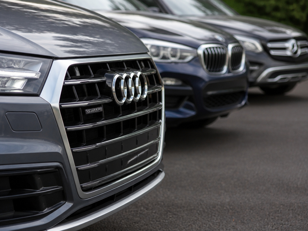 Audi Q5 front end compared to BMW X3 and Mercedes GLC SUVs.