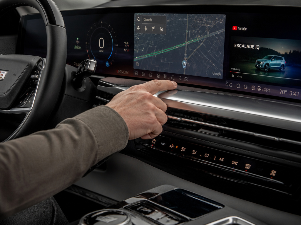 Close-up of Cadillac Escalade's 55-inch dashboard display and premium AKG audio system.
