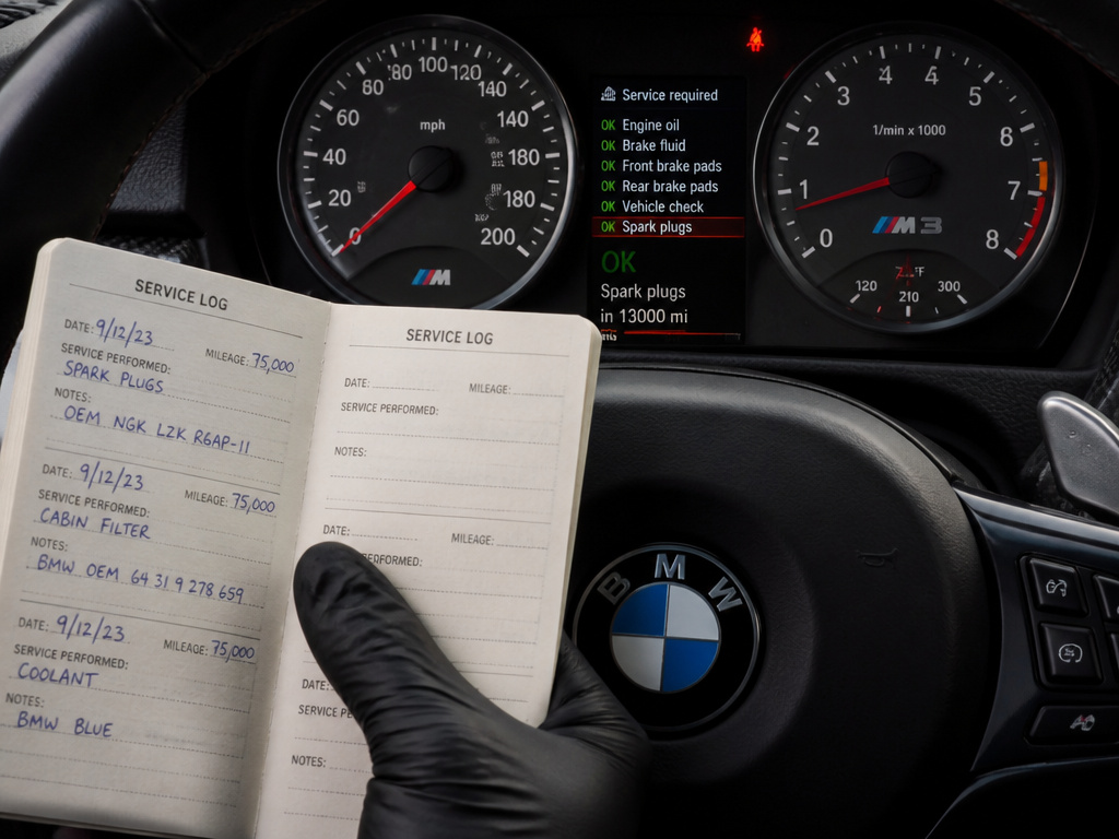 BMW M3 dashboard CBS screen with a maintenance logbook for scheduled services.