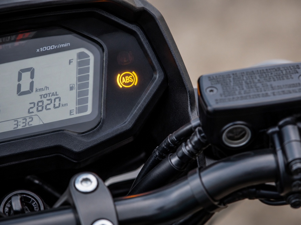 Close-up of a motorcycle's dashboard showing the illuminated ABS malfunction warning light.